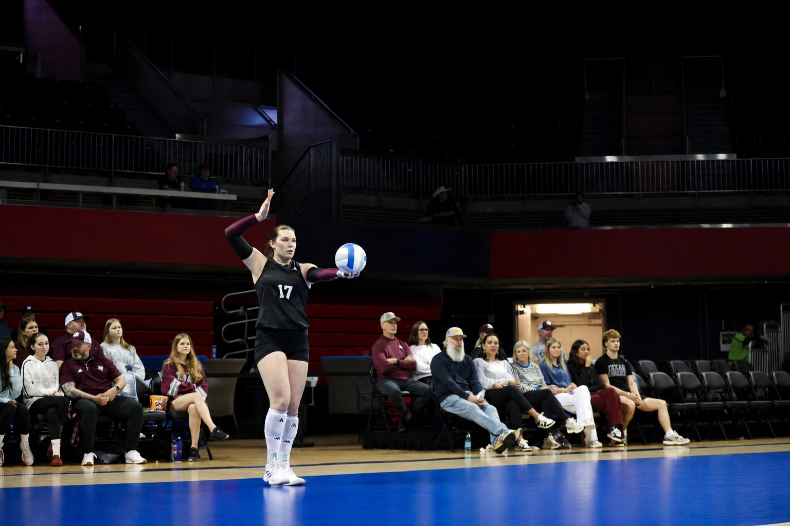 Natalie Ring serving during a college volleyball match